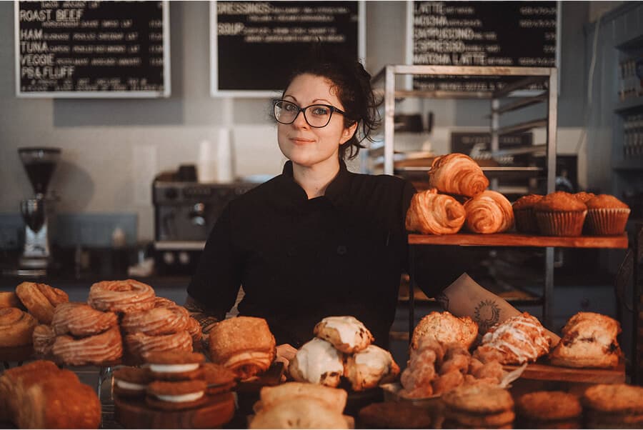 Emma Ozment standing behind pastry display at Middle Street Foods