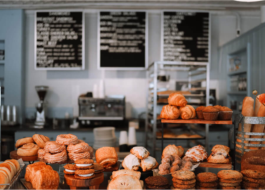 Interior display at Middle Street Foods featuring trays of croissants, muffins, and cookies.